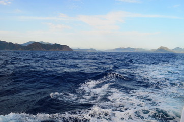 the setting sun in the clouds over the Aegean Sea