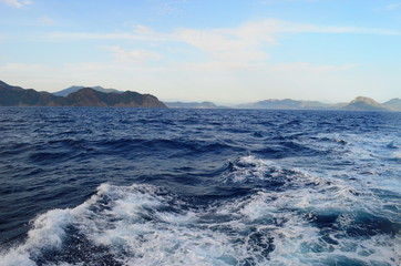 the setting sun in the clouds over the Aegean Sea