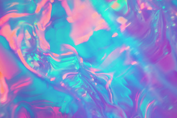 Abstract trendy holographic background in 80s style. Blurred texture in violet, pink and mint colors with scratches and irregularities. Retro futurism, webpunk, disco. Neon colors.
