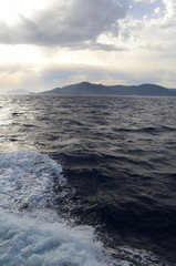 the setting sun in the clouds over the Aegean Sea