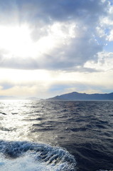 the setting sun in the clouds over the Aegean Sea