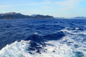 the setting sun in the clouds over the Aegean Sea