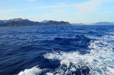 the setting sun in the clouds over the Aegean Sea