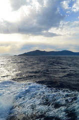 the setting sun in the clouds over the Aegean Sea