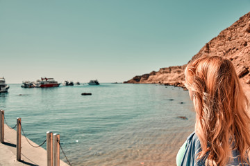 Cruise ship vacation woman enjoying travel vacation at sea. Free carefree happy girl looking at ocean or sea. Woman on a yacht enjoying the beautiful vacation.