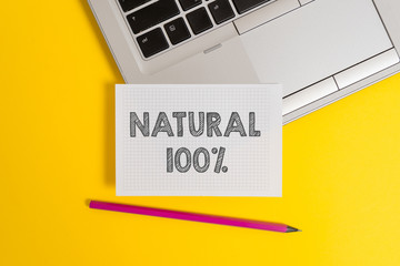 Handwriting text writing Natural 100 Percent. Conceptual photo Minimally processed and does not contain artificial flavors Top trendy metallic laptop pencil squared paper sheet colored background