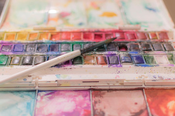 palette with paints and brushes