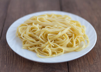 pasta, plate of cooked spaghetti on wooden background