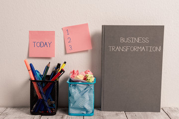 Text sign showing Business Transformation. Business photo showcasing Align their Trade models with Strategy Improvement Stick Pad Notes on Wall Two Pencil Pots Hardcover Notebook on Work Desk