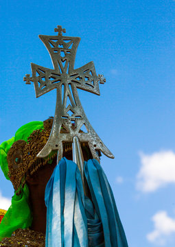 Ethiopian orthodox priest holding a cross during the colorful timkat epiphany festival, Lalibela, Ethiopia