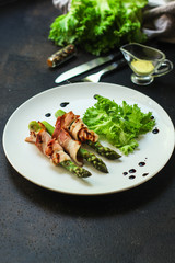 Asparagus in bacon, delicious grilled vegetables with meat wrapped. food background. top view. copy space