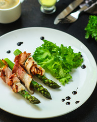 Asparagus in bacon, delicious grilled vegetables with meat wrapped. food background. top view. copy space