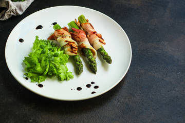 Asparagus in bacon, delicious grilled vegetables with meat wrapped. food background. top view. copy space
