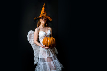 Halloween people in angel costume. Fashion Art Halloween design scene. Halloween Party girl. Female...