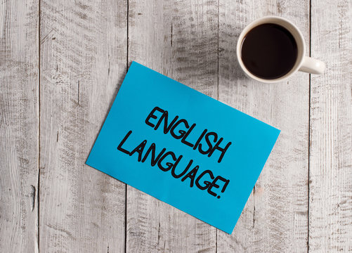Text sign showing English Language. Business photo showcasing third spoken native lang in world after Chinese and Spanish Pastel Colour paper placed next to a cup of coffee above the wooden table