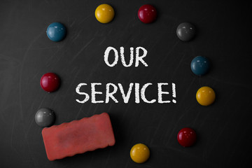 Word writing text Our Service. Business photo showcasing announcing as repair or provide maintenance for product Round Flat shape stones with one eraser stick to old chalk black board