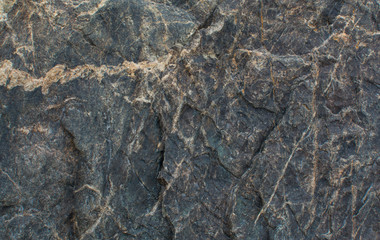 Dark colored stone. The texture of the stone. Natural background.