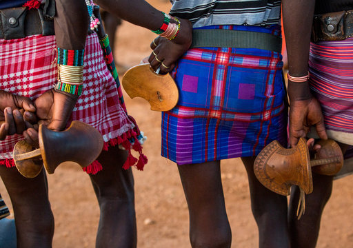 Bashada tribe men with their wooden pillows, Dimeka, Omo valley, Ethiopia.
