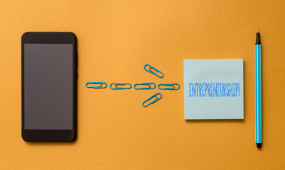 Writing note showing Entrepreneurship. Business concept for Process of designing launching and running a new business Colored sticky note clips smartphone pen trendy cool pastel background