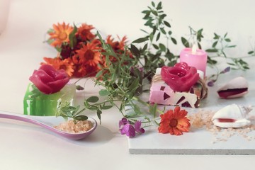 Natural soap, sea salt, flowers, shells on a light background, spa preparation, relax