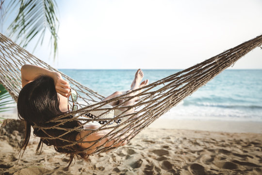 Happy woman relax in hammock