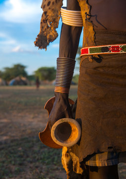 Dassanech man with his wooden pillow during dimi ceremony to celebrate circumcision of the teenagers, Omo valley, Omorate, Ethiopia