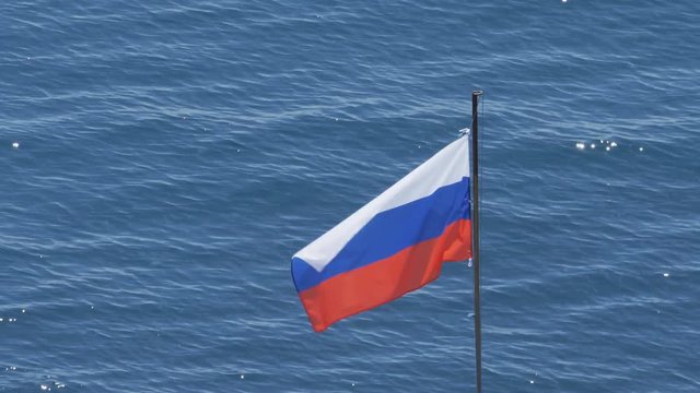Russian flag on the background of the sea.