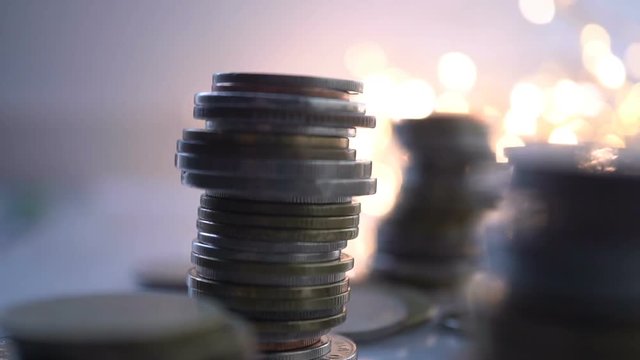 Double exposure of city view and rows of coins for finance , money , investment and business concept background