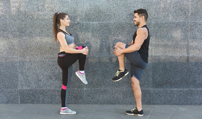 Happy young couple training in the city