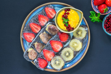 Chia seeds and fruit rice paper rolls with mango dipping sauce - top view