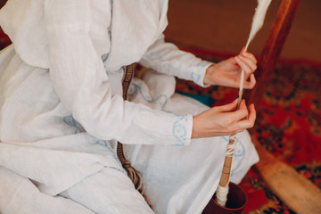 Obraz na płótnie Canvas Woman makes thread, yarn and fabric