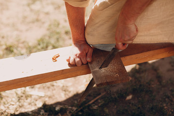 Carpenter sawing board with a hacksaw