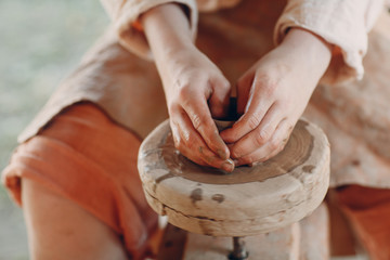 Potter makes a pot of clay