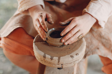 Potter makes a pot of clay