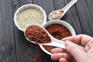 hand holdind a spoon with red and steamed rice mix