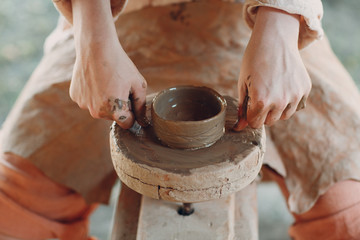Potter makes a pot of clay