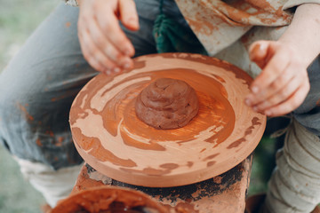 Potter makes a pot of clay