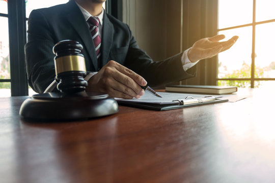 Lawyer present client with contract papers on the table in office. consultant lawyer, attorney, court judge, concept.