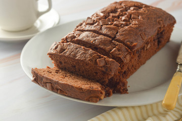 Chocolate pound cake. Homemade dark chocolate pastry for breakfast or dessert, bright background.