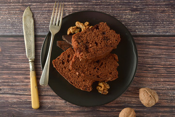 Piece of chocolate cake , fudge or pound cake. Wooden background.