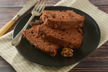 Piece of chocolate cake , fudge or pound cake. Wooden background.