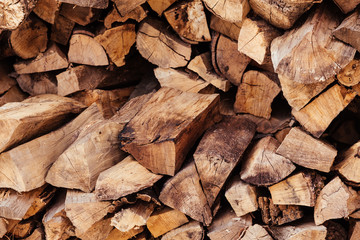 Close-up wooden logs folded in the form of woodpile lie on the street. Concept of rustic background...