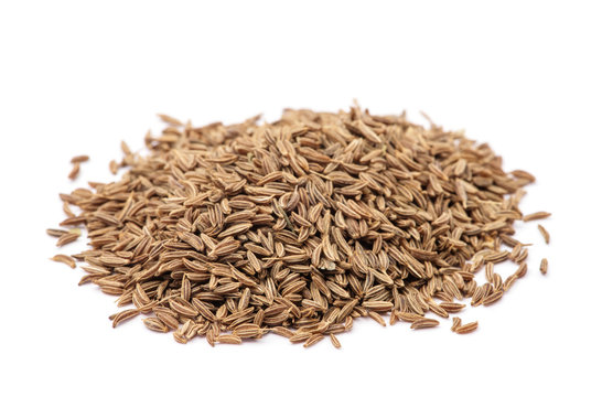Pile of cumin seeds isolated on white background