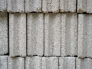 Pattern of grey concrete cement block bricks at  construction site.
