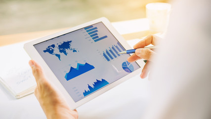 businessman working on project for analyzing company financial report balance statement with documents graphics at modern office space. Concept picture of business,economy, market,money and tax.