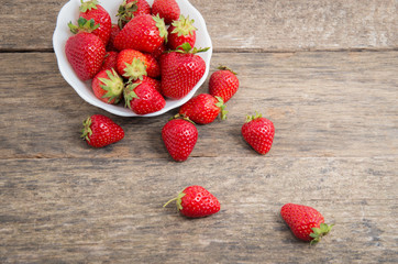 Ripe red strawberries on wooden table