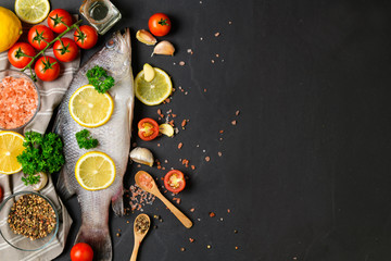 Fresh fish seabass and ingredients for cooking.