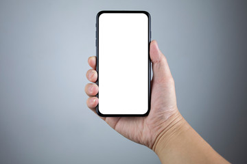 Man hand holding the smartphone full screen with blank screen . isolated on gray background.