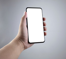 Man hand holding the smartphone full screen with blank screen . isolated on gray background.