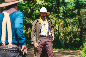 cowboy with gun prepares to gunfight. 
